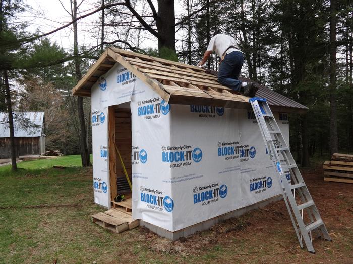 House wrap to block drafts (gets to -30F here). Roof metal going on.