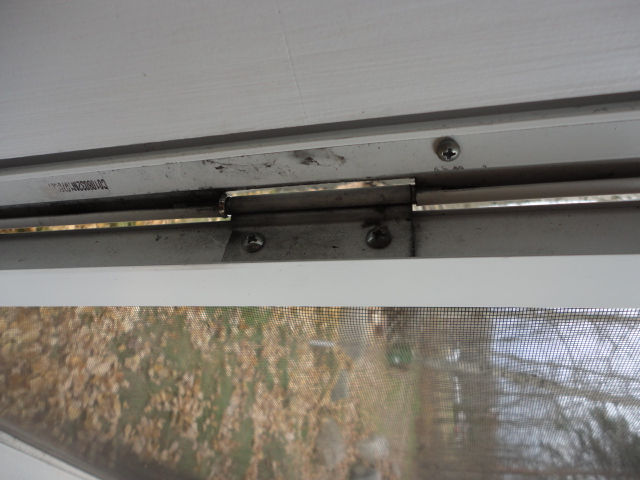 A close up image of the door reattached to one of the hinges.