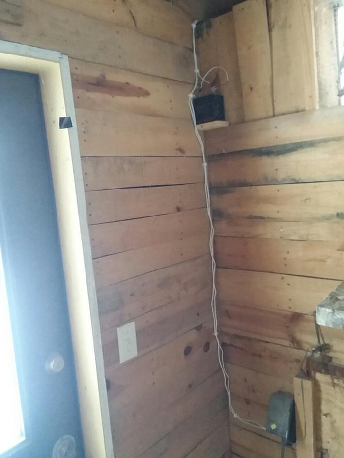 Wires run through wall into coop