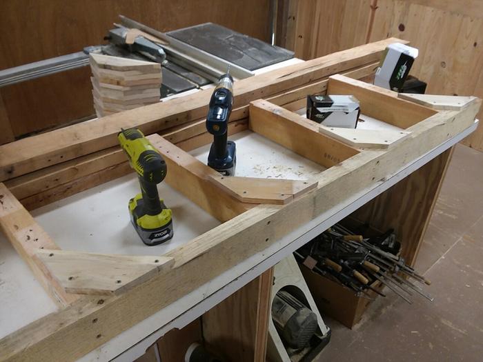 Angled the shelf brackets about 5 degrees and braced with pallet wood