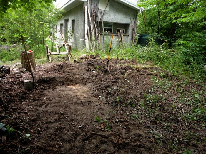 In this photo I have started clearing the land by hand and leveling it out enough to work. I'll note there was a lot of poison ivy!