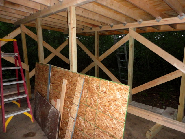 An interior shot showing the hurricane brackets attaching the rafters and cross bracing on the walls to stabilize it all.