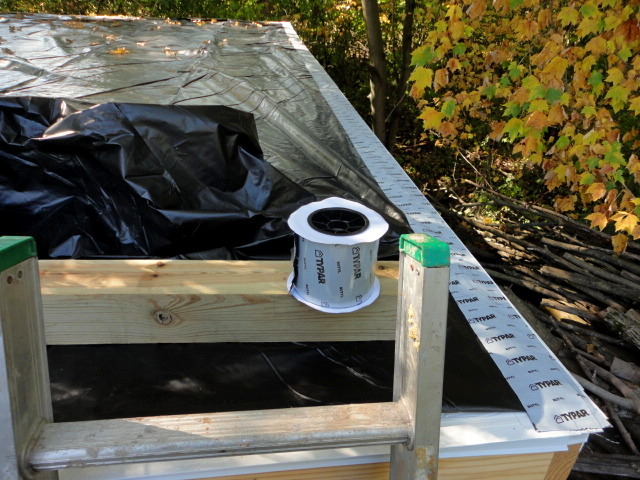 Using roll flashing I "taped" down the heavy plastic for the roof to the metal drip edging.