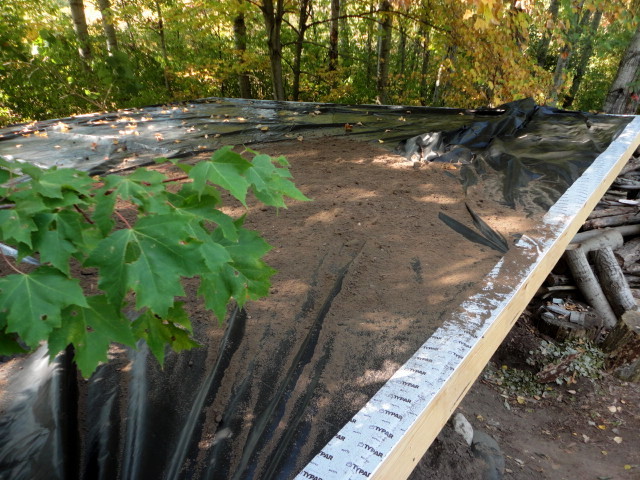 A photo of the first wheelbarrow load of soil thrown up onto the roof. Whew! There is a lot to go!