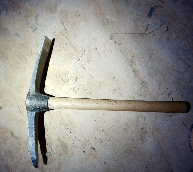 Round tipped pick axe with diameter similar to an acorn.