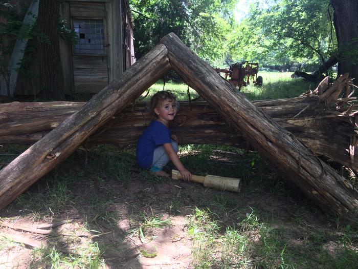 The wee one, testing structural integrity with a mallet made for the PEP roundwood badge.