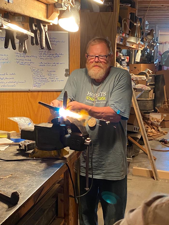 Jim heating up a railroad spike so we could bend it