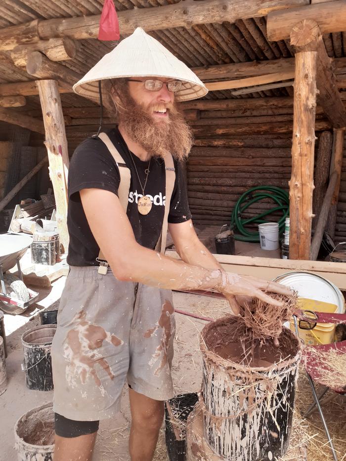 Dipping straw into clay slip