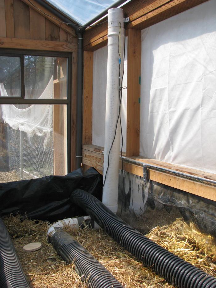 Corrugated drain pipe across the tops of the bales attached to a 12volt bilge vent fan.