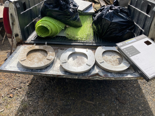 Three old white seats on the way to the landfill