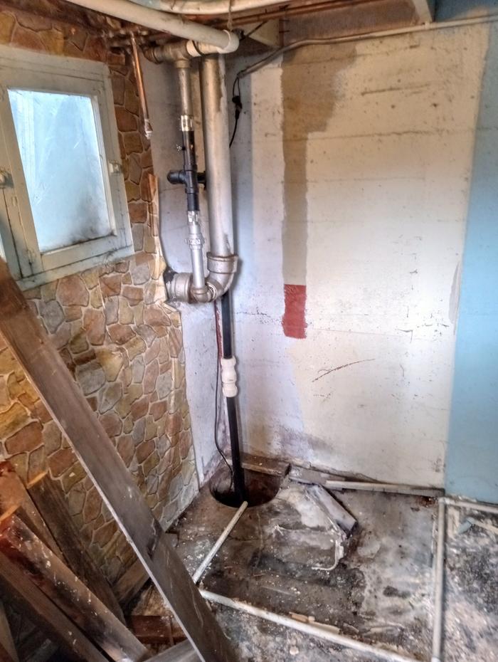 The white pvc on the floor is the drain from the water heater. It went around the shower.