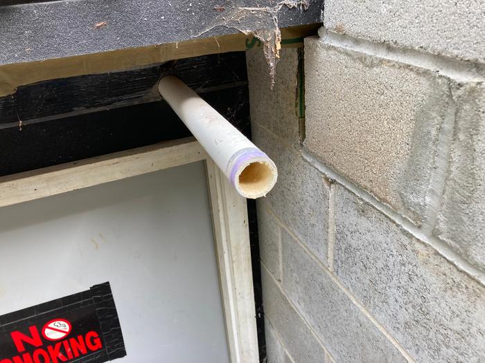 Sump pump drain line coming out of the house