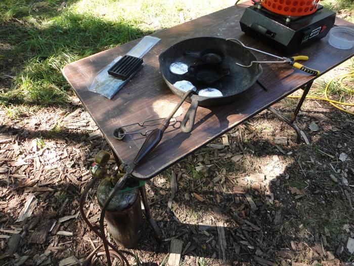 The large cast iron pan is to catch any potential spills. Molten metal is dangerous!!! I will be casting into one of the small pans set in the larger pan. The tongs are for grabbing the crucible.