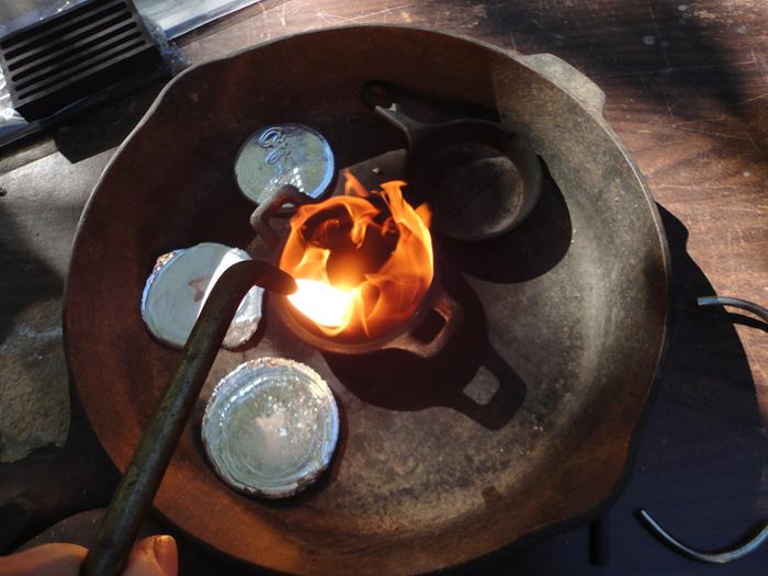 Here I am choking off the air on the torch to alter the flame and carbonize the pan.