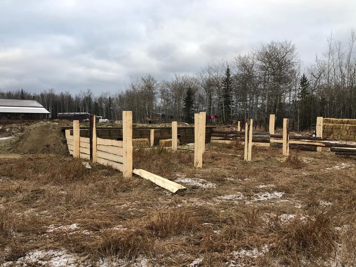 Posts and railing in front of wofati pig shelter