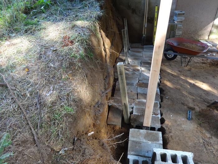 Gratuitous retaining wall photo (used cinder blocks to support angled posts from old footing)