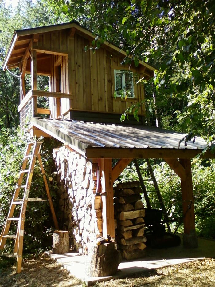 Roofing installed and starting to fill with firewood.