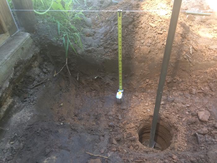 Example of where trench meets post hole in clay subsoil. This is the low point of the site.