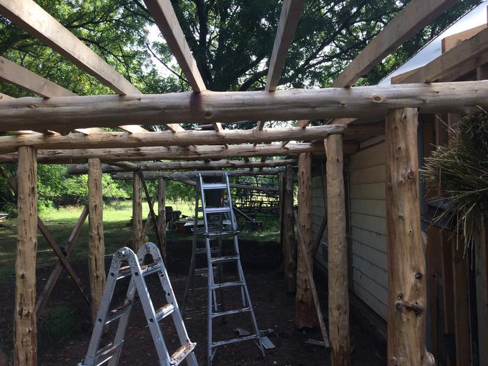 Moving forward with roof support. Reclaimed 16 foot 2x4’s from a civic road project. Power washed and good as new.