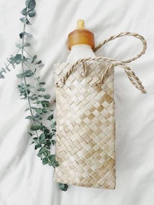 glass baby bottle in woven holder