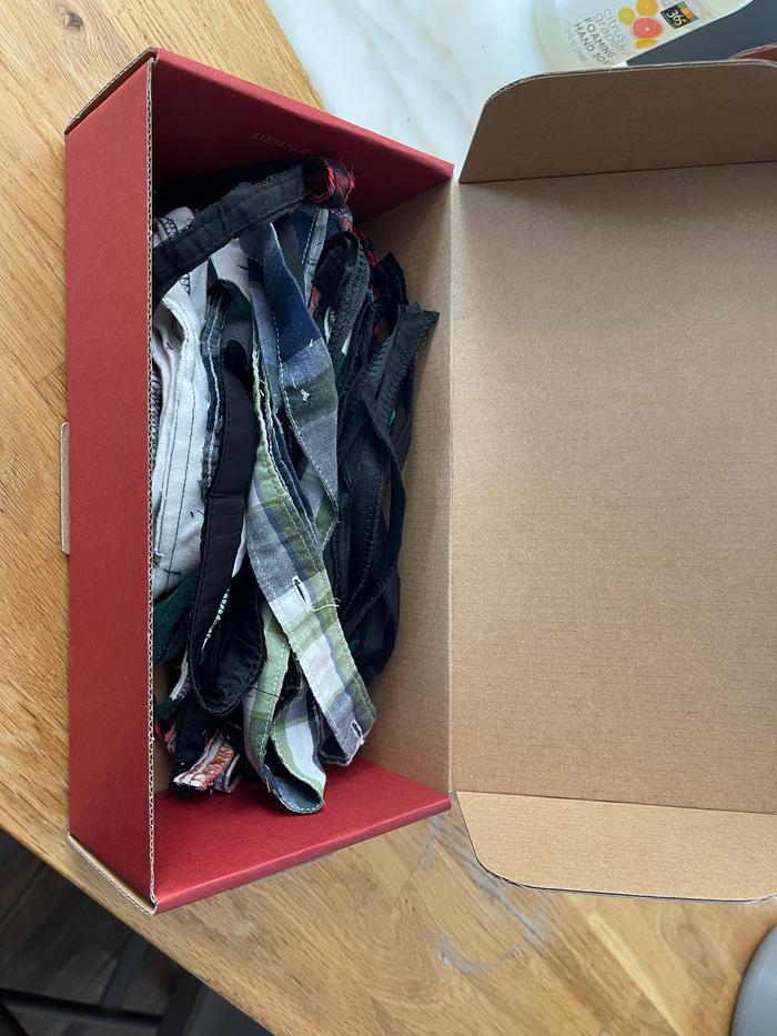 box of harvested button bands from recycled garments