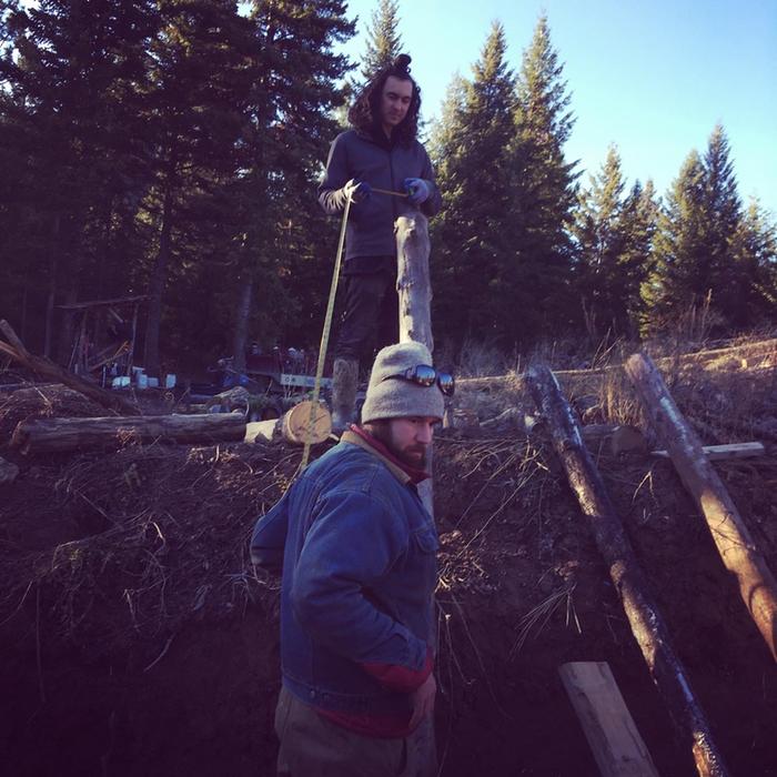 Clayton and Josiah measure a roof pole for the west wing wall