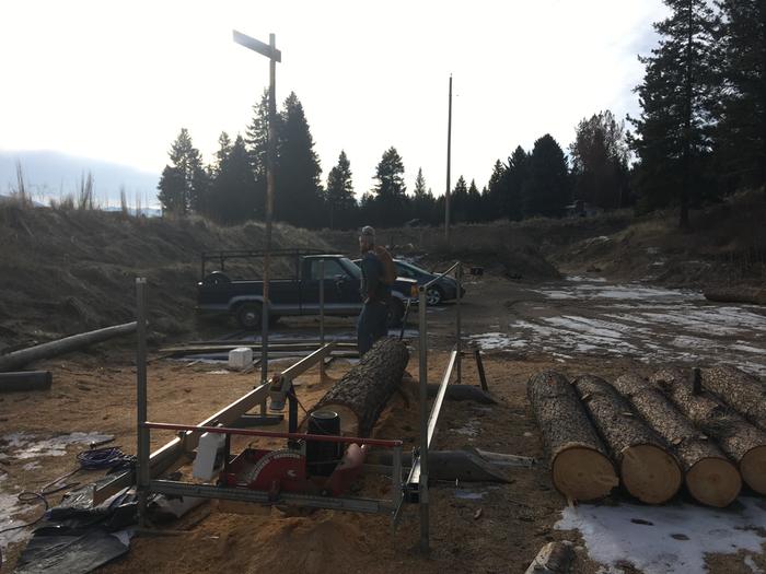 Working on the sawmill with a cat on his back, Josiah 