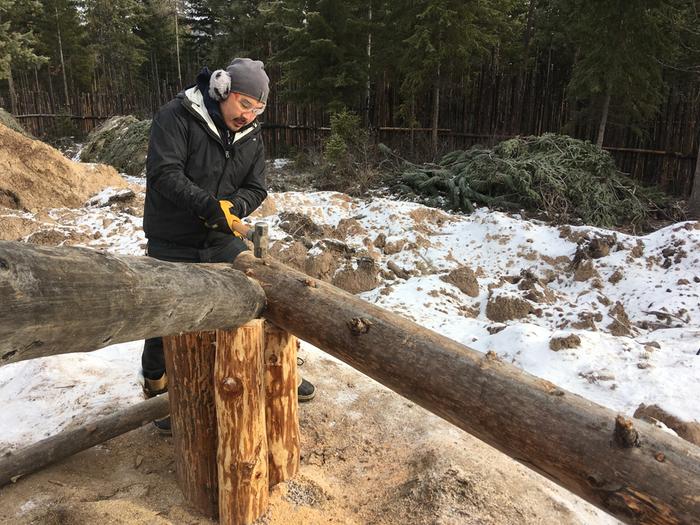 amey happily hammering in the final rebar-nail-spike in the framing