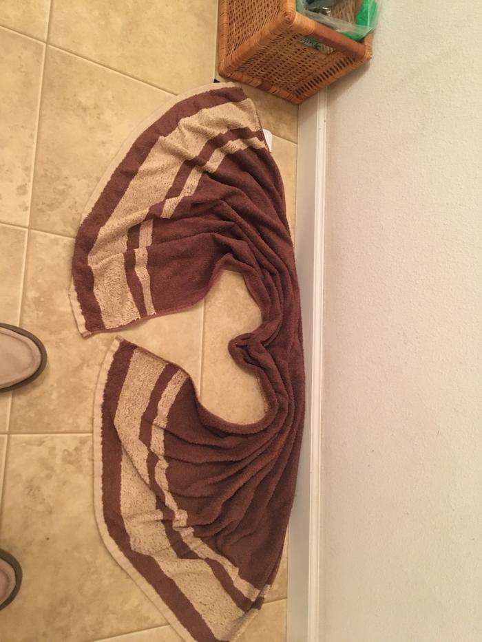 Someone made a heart moth towel with the bathroom rug!