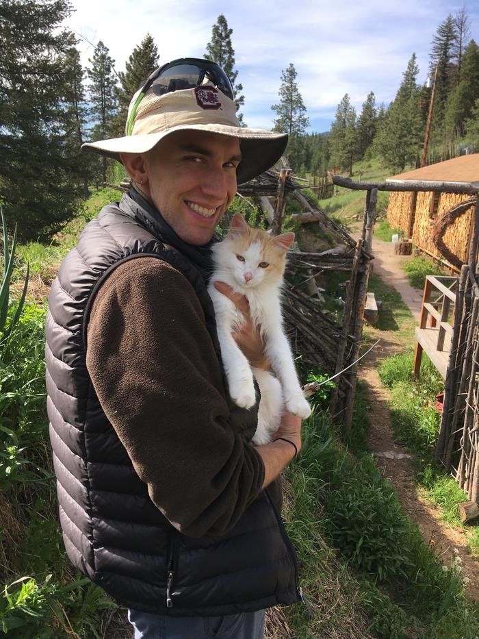 M taking a moment to hug a feline during boot gardening day 