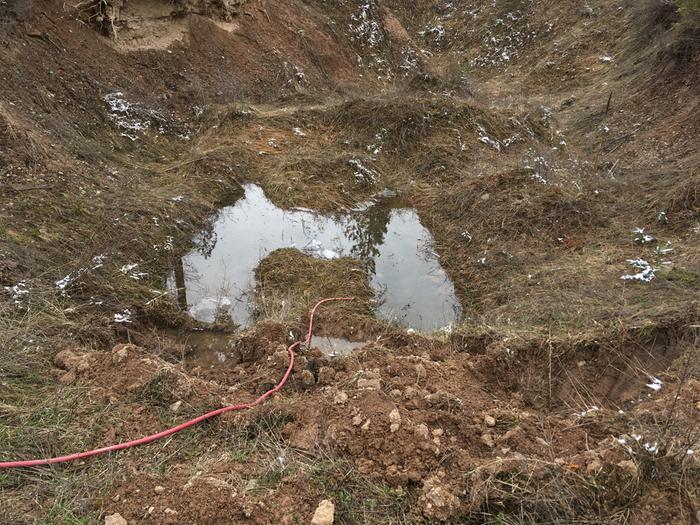 Clay pit .. holds some water.. you can see where the ice “lifted” off as the water sank down