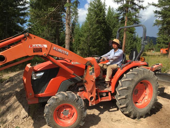 H tries a hand at the tractor