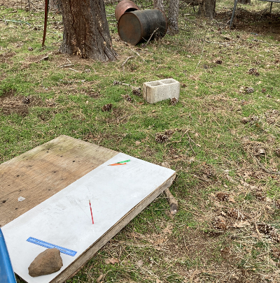 Solar finder in the foreground with a cinder block marking the location of the permanent marker