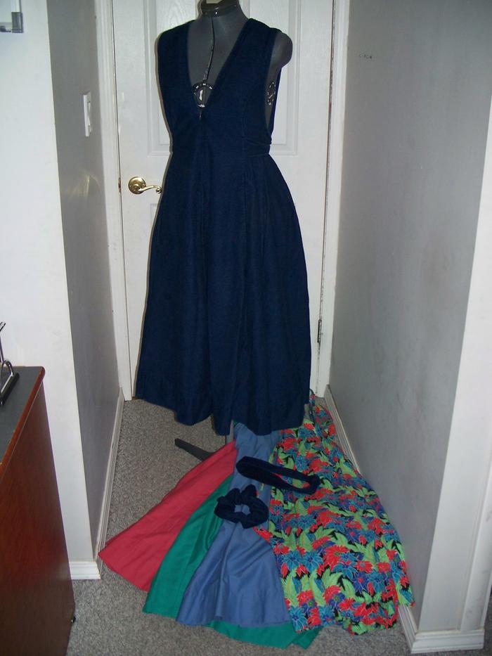 I made a set of dresses in this style, most all made of denim and not as full skirted, fitted by tying a bow in the back