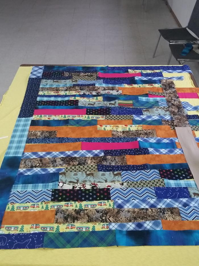 cloth strips laid out for a quilt