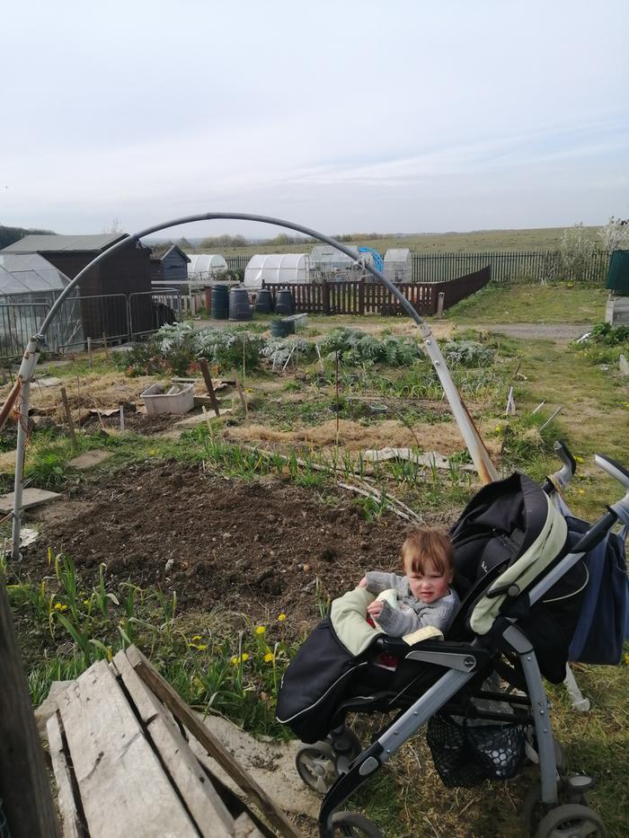 Baby girl helping clear away the grass