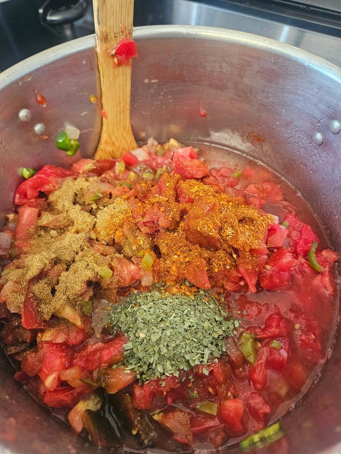 Seasoning the salsa as it cooks down