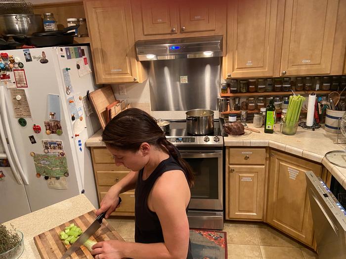 Alexandra chopping celery in the fisher price house at wheaton labs