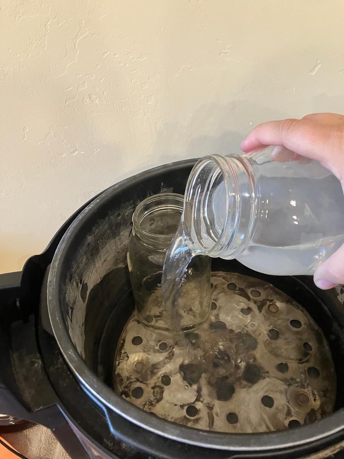 Time for carrots. Adding a little water to the pressure canner.