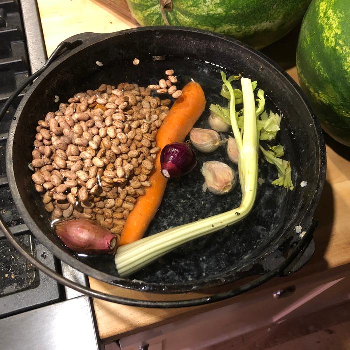 Dry beans and aromatics in water. 