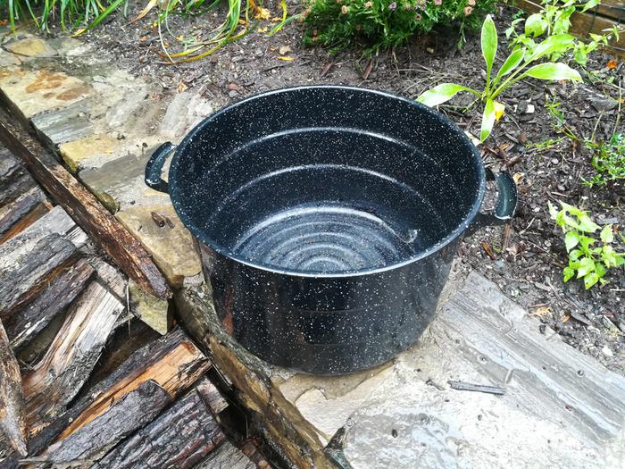 Old enamel pot with slight corrosion where it was dented