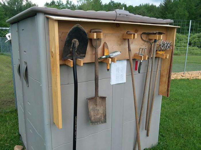 Tool shed with tools and a map of the garden