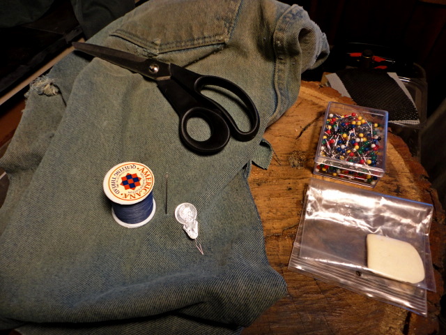 The tools, and materials I'll be using for the repair, including the other worn pair of jeans donating the patch material.