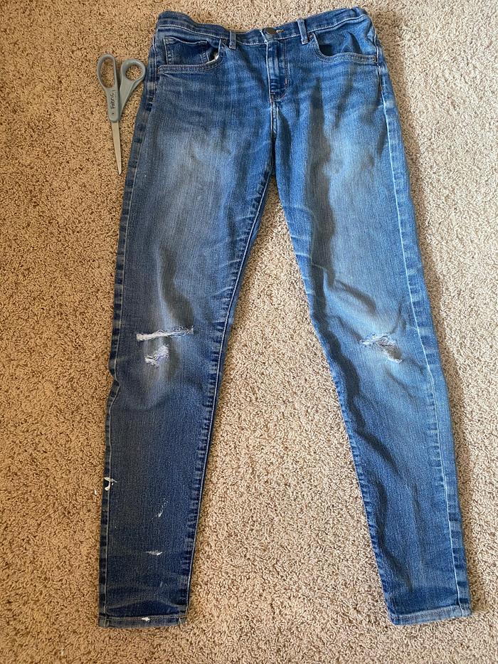 The old jeans, with scissors next to them.