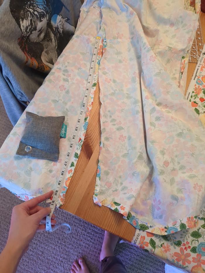 Using the seam ripper to rip apart the skirt seams.