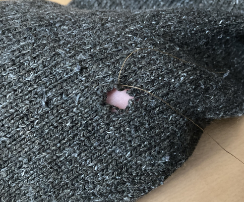 Smaller whole with thread tied to broken yarn