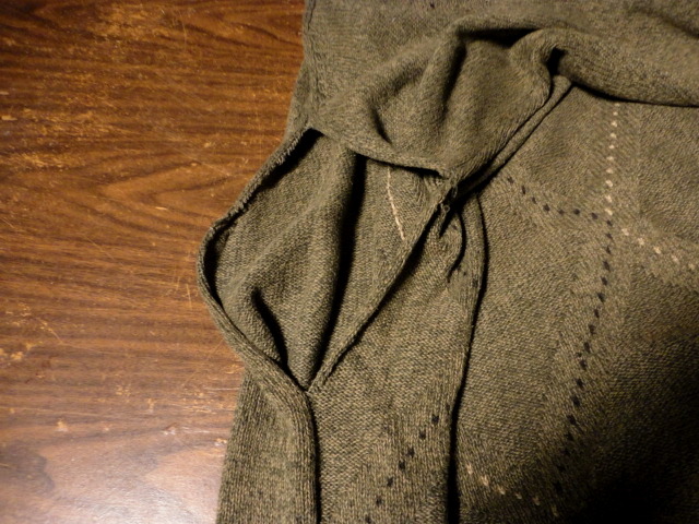 Here is a photo of the large hole in the sweater where the panels are coming apart.