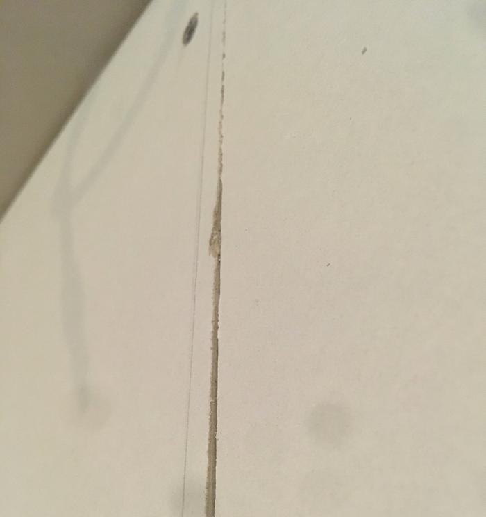 The top, at the ceiling, where the sheets are flush