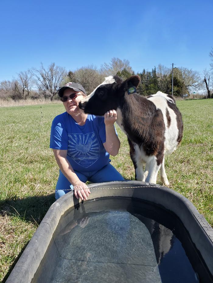young cow with her owner