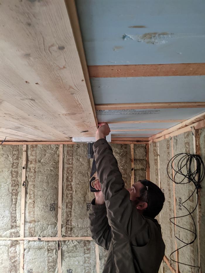 Daniel installing ceiling boards